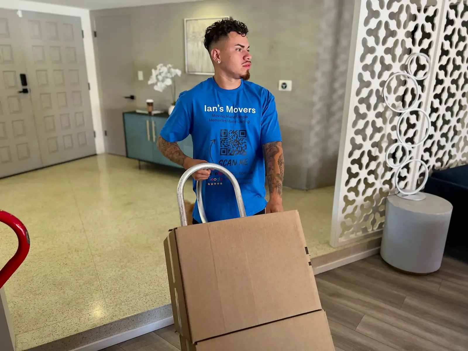Ian's Movers mover using a dolly for packed boxes